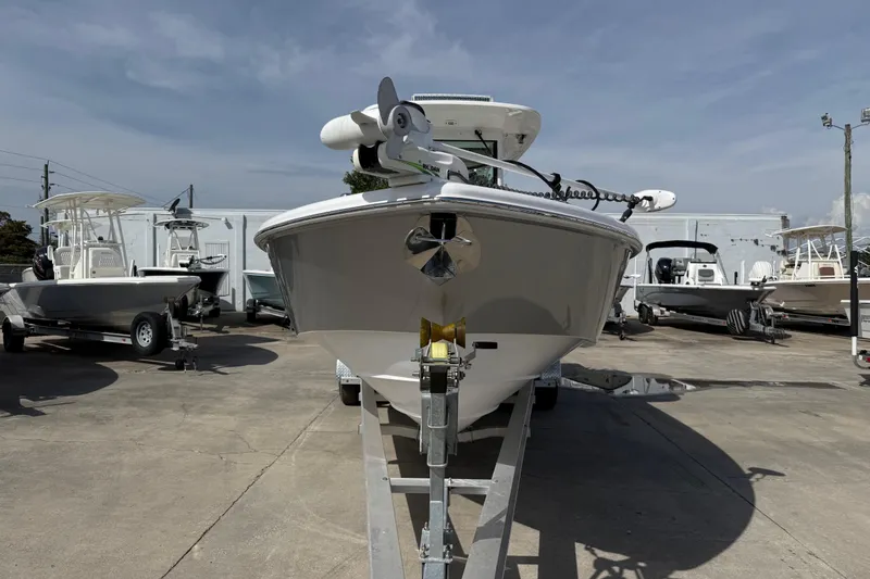 Slide: The Image of 2020 Everglades 273 Center Console boat on trailer in a marina. - 2