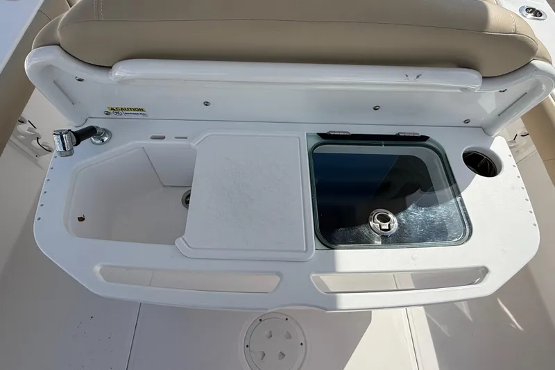 Slide: The Image of Everglades 273 Center Console 2020 boat sink and storage area with beige seating. - 21