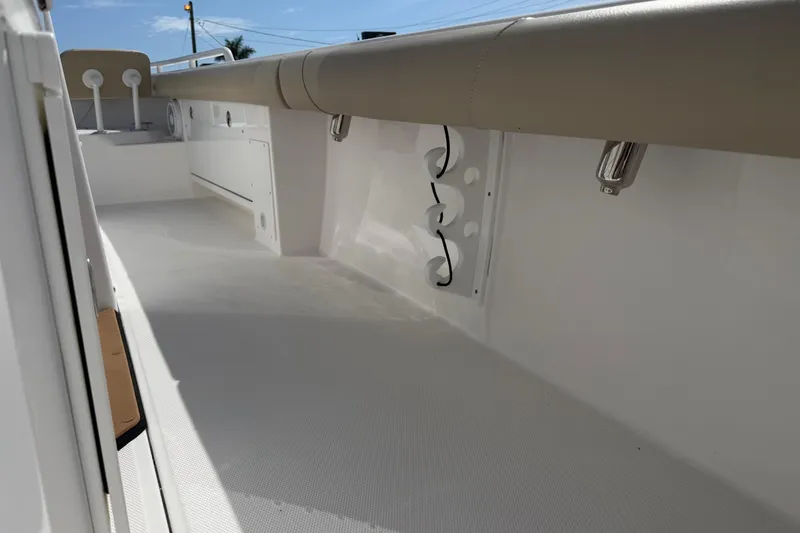 Slide: The Image of 2020 Everglades 273 Center Console boat interior with sleek white deck and cushioned seating. - 22