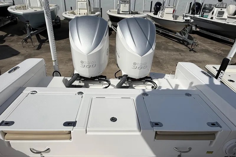 Slide: The Image of 2020 Everglades 273 Center Console with twin Yamaha 300 engines, docked among other boats. - 27