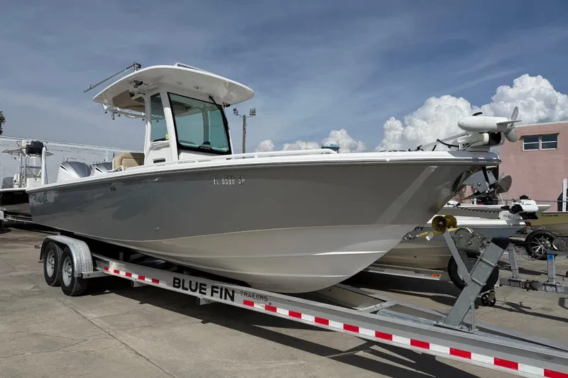 Slide: The Image of 2020 Everglades 273 Center Console boat on Blue Fin trailer, parked outdoors. - 4