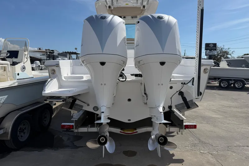 Slide: The Image of 2020 Everglades 273 Center Console boat with dual outboard engines, docked outdoors. - 7