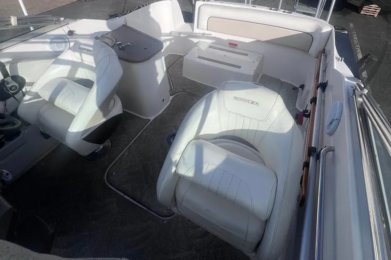 Slide: The Image of 2007 Rinker 230 Captiva Atlantic boat interior with white seating and steering area. - 15