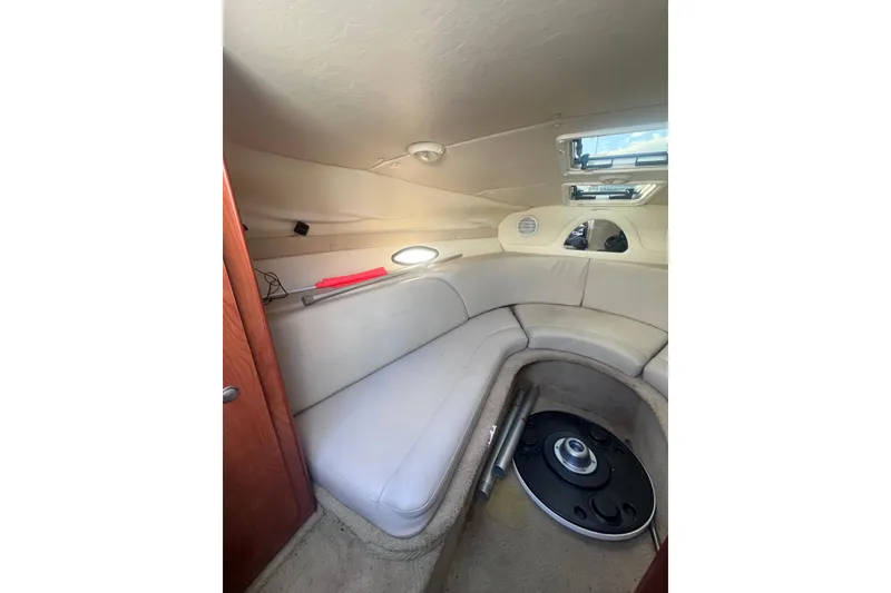 Slide: The Image of Interior of 2007 Rinker 230 Captiva Atlantic boat with beige seating and porthole window. - 16