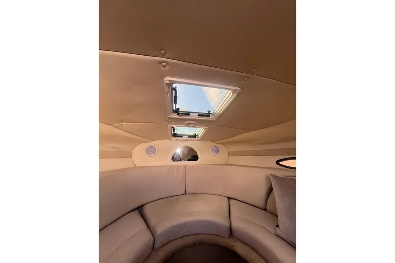 Slide: The Image of Interior of 2007 Rinker 230 Captiva Atlantic boat with skylight and cushioned seating. - 18