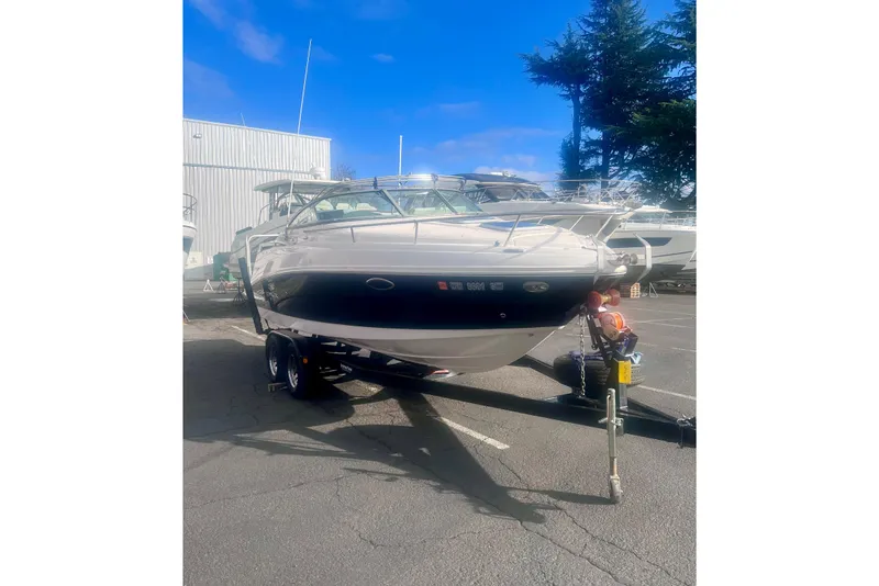Slide: The Image of 2007 Rinker 230 Captiva Atlantic boat on trailer in parking lot. - 2
