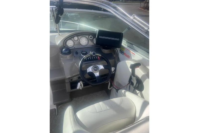 Slide: The Image of 2007 Rinker 230 Captiva Atlantic boat dashboard with steering wheel and Humminbird device. - 20