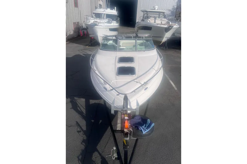 Slide: The Image of 2007 Rinker 230 Captiva Atlantic boat on trailer, parked near other boats. - 4