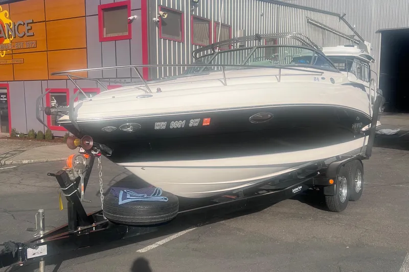 Slide: The Image of 2007 Rinker 230 Captiva Atlantic boat on trailer, parked outside a building. - 6