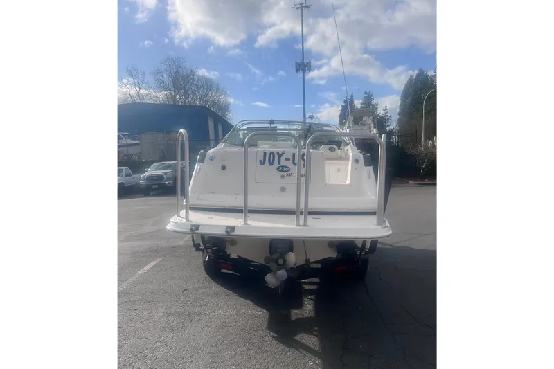 Slide: The Image of 2007 Rinker 230 Captiva Atlantic boat, rear view, parked outdoors under a cloudy sky. - 9