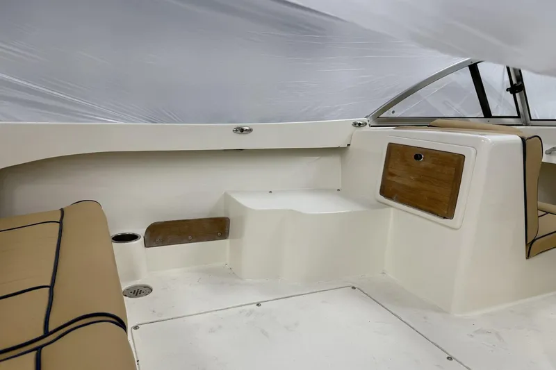 Slide: The Image of 2022 Rossiter 17 Closed Deck interior with beige seating and wood accents. - 10