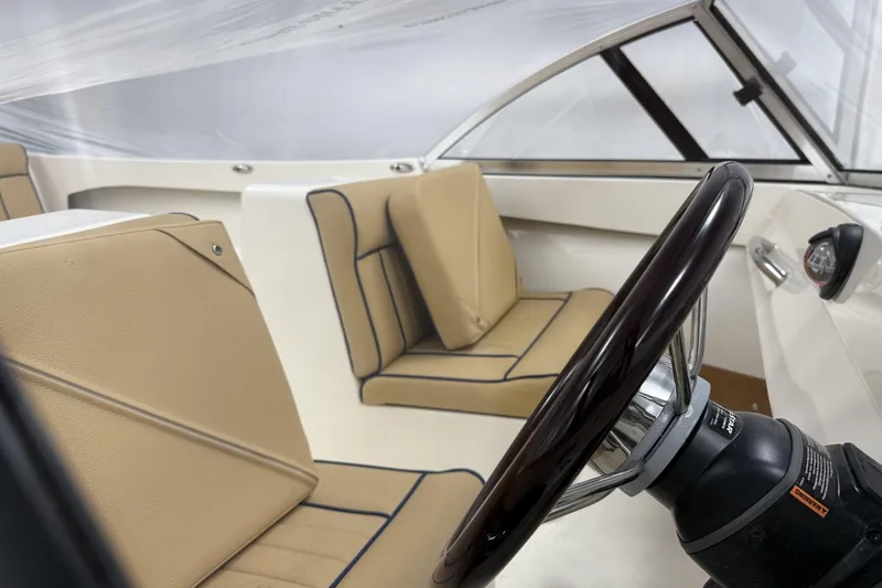 Slide: The Image of 2022 Rossiter 17 Closed Deck interior with tan seating and steering wheel. - 13
