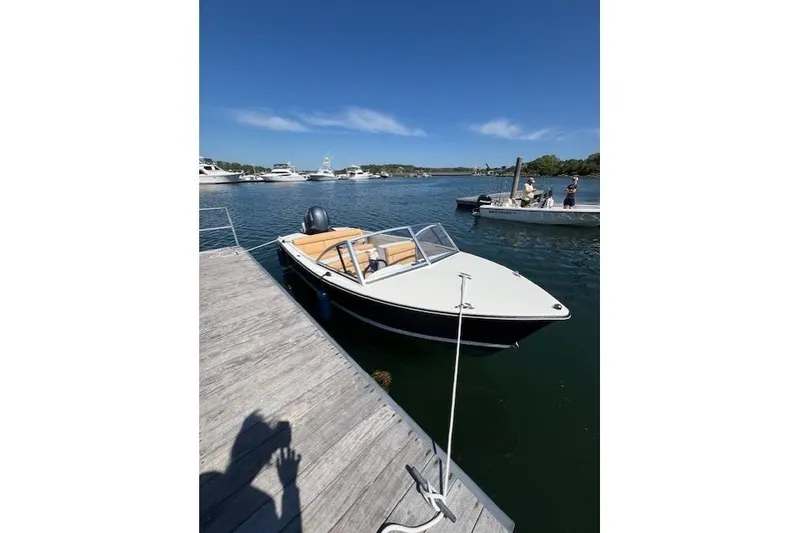 Slide: The Image of 2022 Rossiter 17 Closed Deck boat docked on a sunny day. - 4