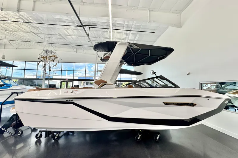 The Image of 2026 Nautique Super Air Nautique G23 boat displayed in a showroom. - 1