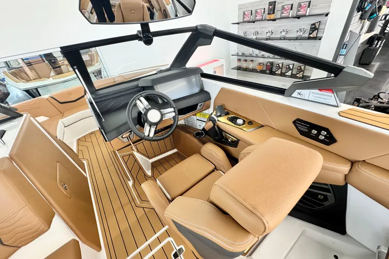Slide: The Image of 2026 Nautique Super Air Nautique G23 boat interior with tan leather seating and modern dashboard. - 7