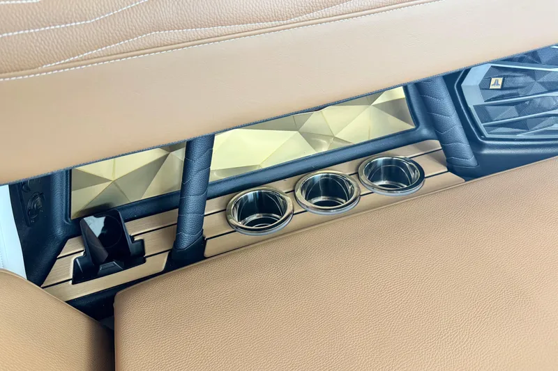 Slide: The Image of 2026 Nautique Super Air Nautique G23 interior with cup holders and luxury detailing. - 9