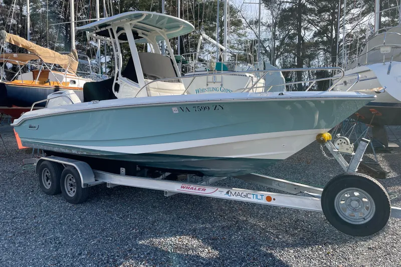 Slide: The Image of 2023 Boston Whaler 220 Dauntless boat on trailer, parked outdoors. - 5