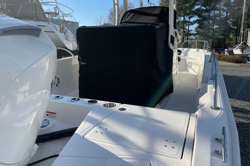 Slide: The Image of 2023 Boston Whaler 220 Dauntless boat interior with covered console and seating area. - 8