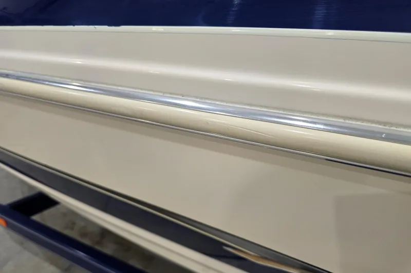 Slide: The Image of 2004 Larson LXi 190 boat hull with blue and beige detailing. - 13