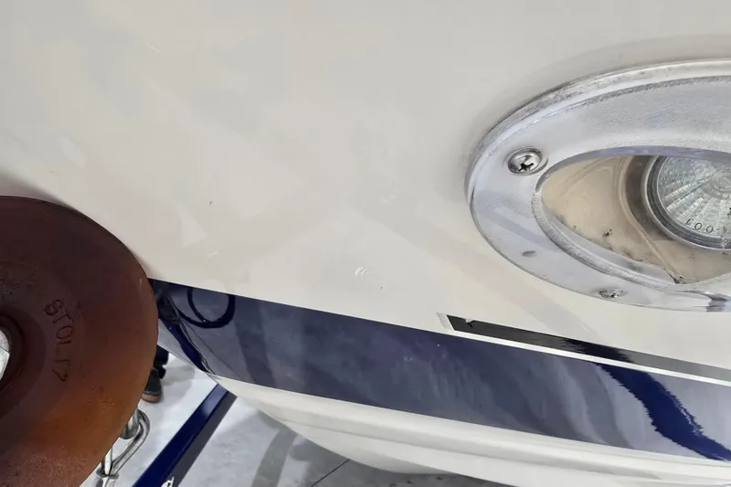 Slide: The Image of Close-up of a 2004 Larson LXi 190 boat's exterior light and hull detail. - 15