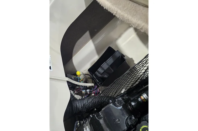 Slide: The Image of Engine compartment of a 2004 Larson LXi 190 boat, showing wiring and components. - 18