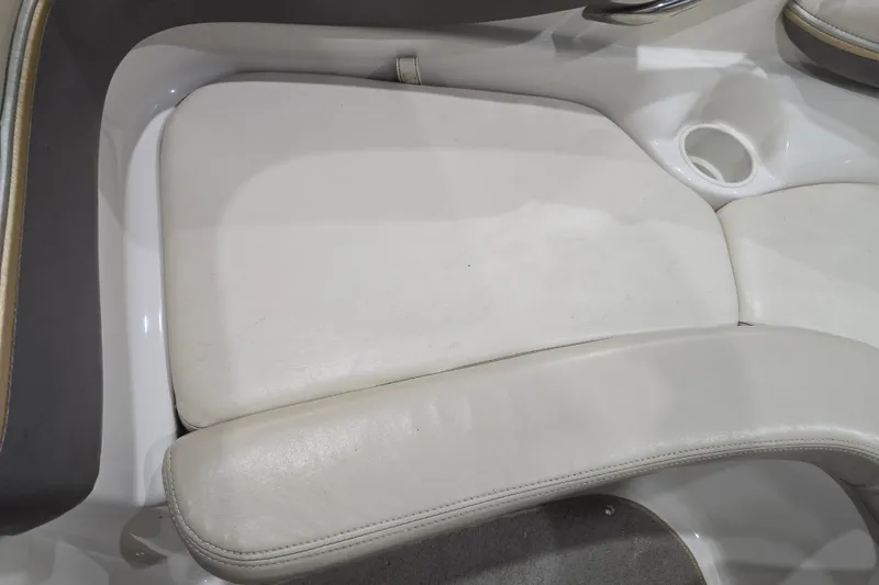 Slide: The Image of White leather seating in a 2004 Larson LXi 190 boat interior. - 23