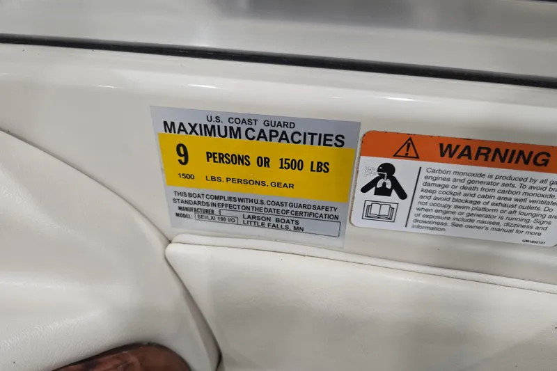 Slide: The Image of 2004 Larson LXi 190 boat capacity label, maximum 9 persons or 1500 lbs, safety warning. - 30