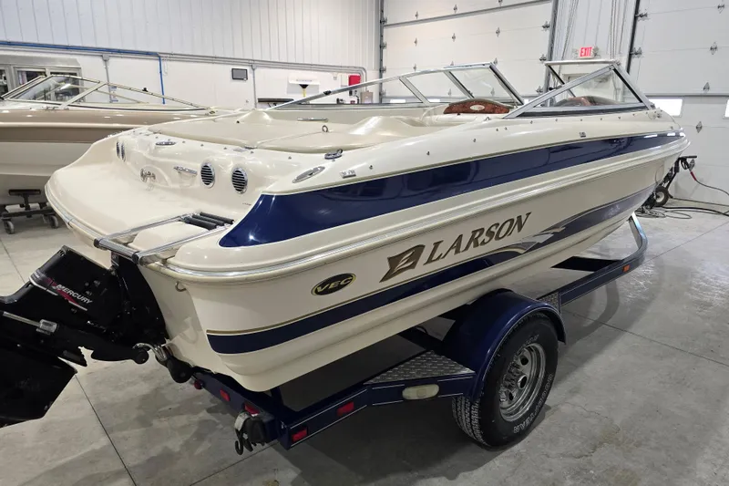 Slide: The Image of 2004 Larson LXi 190 boat on trailer in indoor storage facility. - 4
