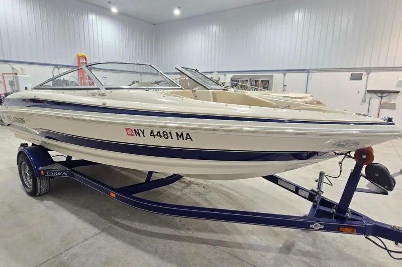 Slide: The Image of 2004 Larson LXi 190 boat on trailer in indoor storage facility. - 5