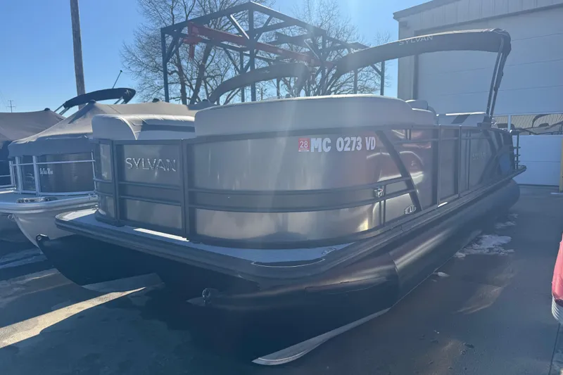 The Image of 2025 Sylvan L3 DLZ pontoon boat parked outdoors in a marina setting. - 0