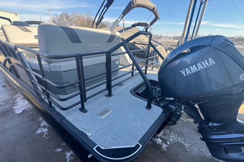 Slide: The Image of 2025 Sylvan L3 DLZ pontoon boat with Yamaha outboard motor, docked on snowy ground. - 15