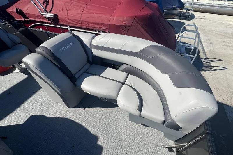 Slide: The Image of 2025 Sylvan L3 DLZ boat seating with gray and white upholstery on a sunny day. - 3