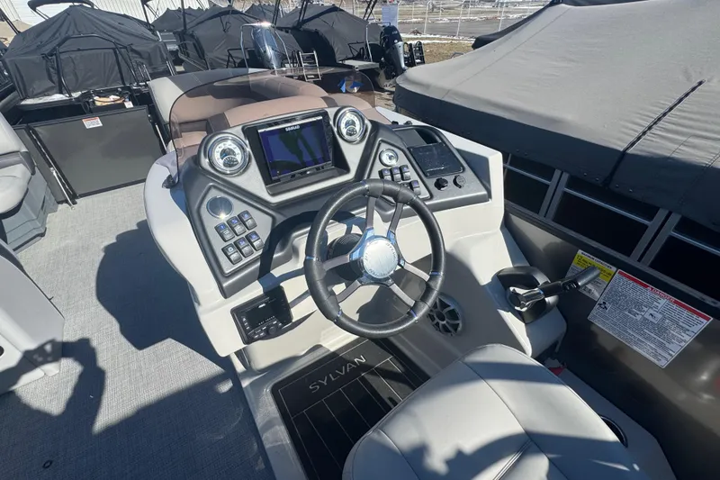 Slide: The Image of 2025 Sylvan L3 DLZ boat dashboard with steering wheel and control panel. - 7