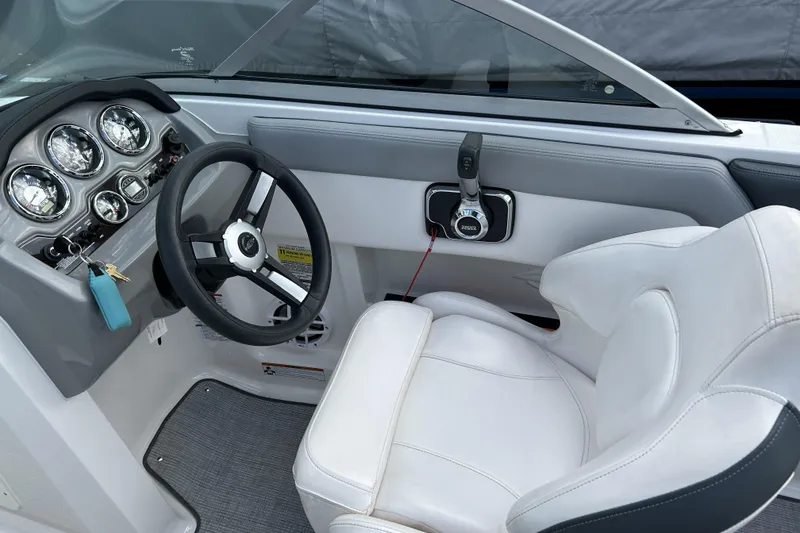 Slide: The Image of 2021 Chaparral 19 SSi boat cockpit with steering wheel and gauges. - 12