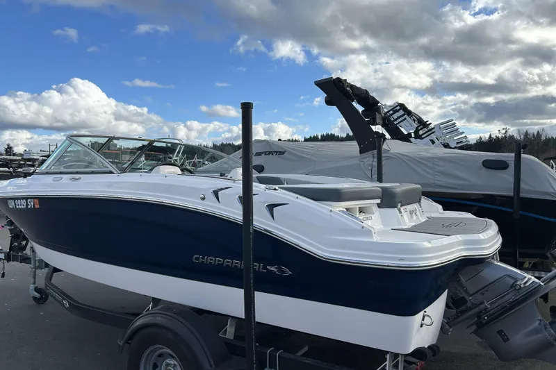 Slide: The Image of 2021 Chaparral 19 SSi boat on trailer under cloudy sky. - 2