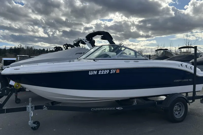 Slide: The Image of 2021 Chaparral 19 SSi boat on trailer under cloudy sky. - 3