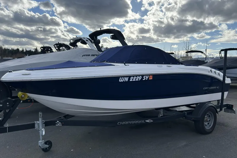 Slide: The Image of 2021 Chaparral 19 SSi boat on trailer under cloudy sky. - 4