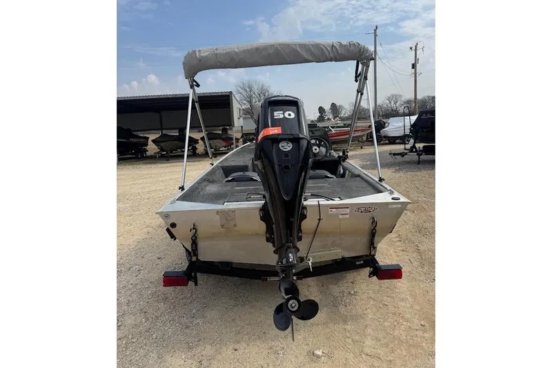 Slide: The Image of 2015 Tracker Pro 170 boat with 50 HP motor, parked outdoors. - 11