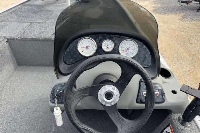 Slide: The Image of 2015 Tracker Pro 170 boat dashboard with steering wheel and gauges. - 14