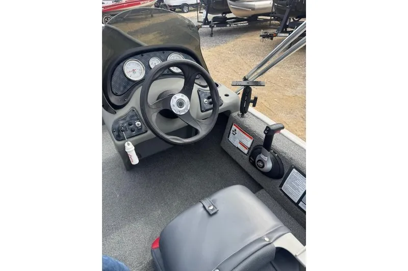 Slide: The Image of 2015 Tracker Pro 170 boat cockpit with steering wheel and control panel. - 15