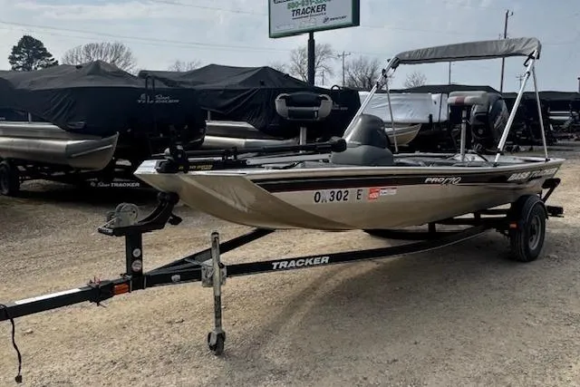 Slide: The Image of 2015 Tracker Pro 170 boat on trailer, parked outdoors with other boats. - 9