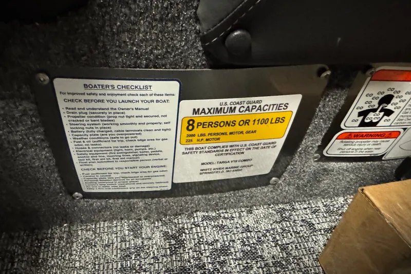 Slide: The Image of 2026 Tracker Targa V-19 Combo capacity plate, seating 8 or 1100 lbs, with boater's checklist. - 10