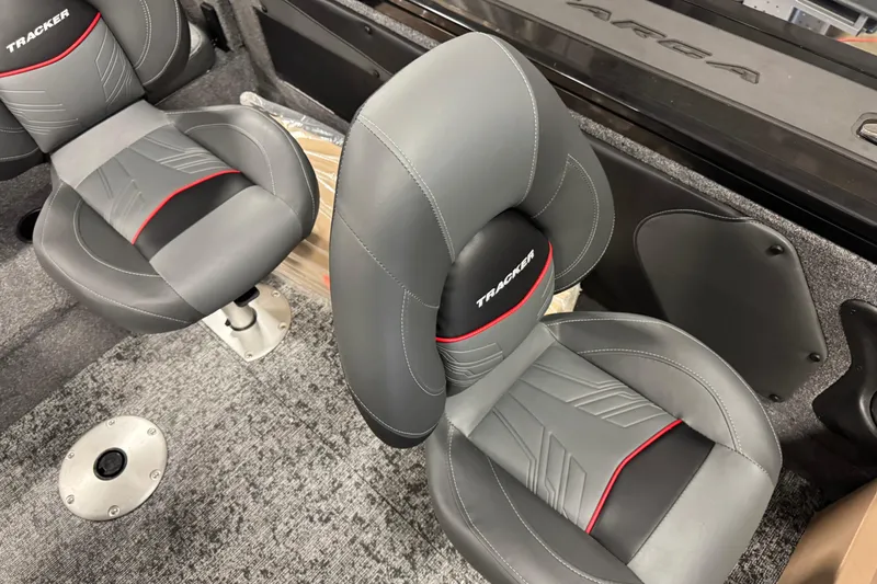 Slide: The Image of 2026 Tracker Targa V-19 Combo boat seats with gray and red accents. - 11