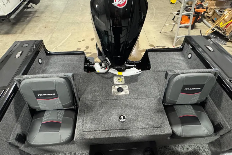 Slide: The Image of 2026 Tracker Targa V-19 Combo boat interior with dual seats and motor. - 14