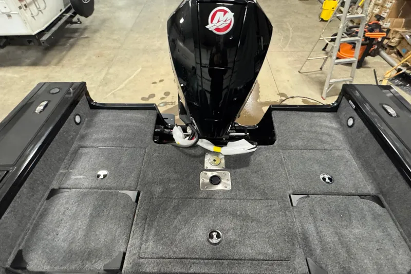 Slide: The Image of 2026 Tracker Targa V-19 Combo boat interior with motor, gray carpeted deck. - 15