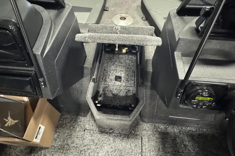 Slide: The Image of Interior view of 2026 Tracker Targa V-19 Combo boat, featuring storage compartment and control panel. - 17