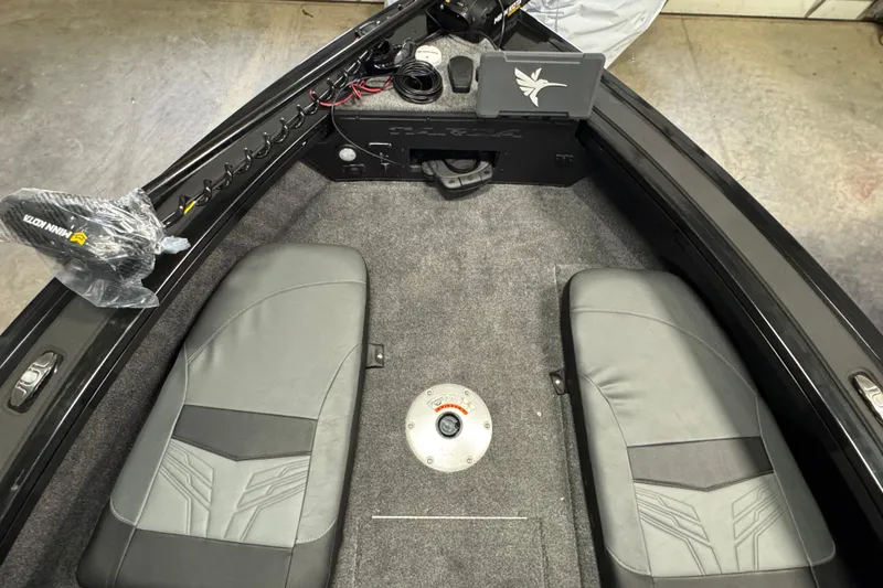 Slide: The Image of 2026 Tracker Targa V-19 Combo boat interior with dual seats and carpeted flooring. - 18