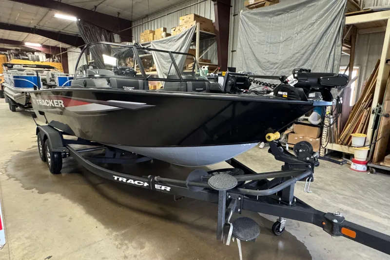 Slide: The Image of 2026 Tracker Targa V-19 Combo boat in a warehouse, on a trailer. - 2