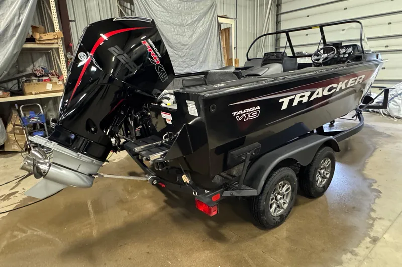 Slide: The Image of 2026 Tracker Targa V-19 Combo boat in garage, featuring powerful outboard motor. - 3