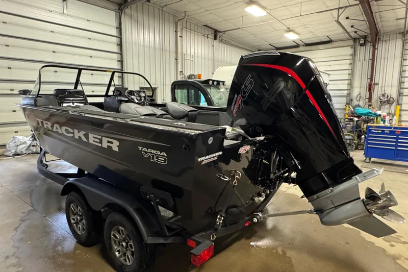 Slide: The Image of 2026 Tracker Targa V-19 Combo boat in a garage, featuring a powerful outboard motor. - 4